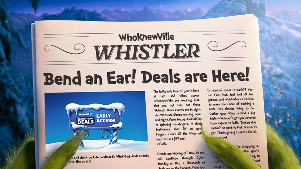 A close-up of the WhoKnewVille Whistler newspaper featuring a headline 'Bend an Ear! Deals are Here!' and an advertisement for 'WhoKnewVille's Black Friday Deals' with 'Early Access!' text. The background showcases a snowy mountain landscape under a vibrant blue sky. Green grass blades frame the foreground, adding a natural touch to the scene.